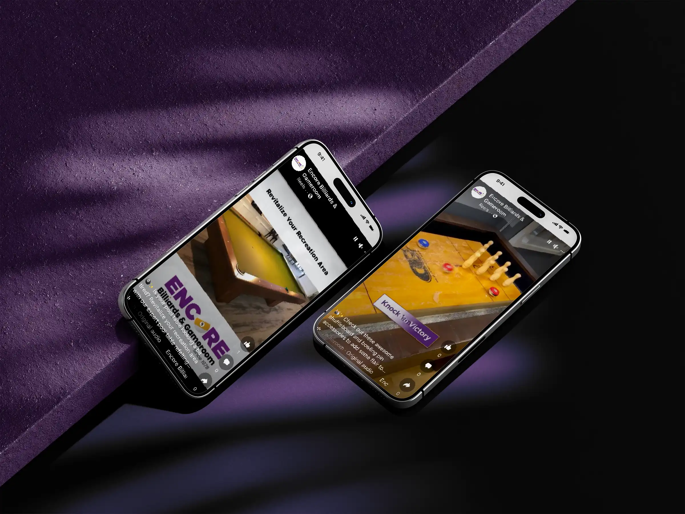 Two smartphones angled on a dark purple surface, each displaying a social media post from "Encore Billiards & Gameroom." One shows a pool table refelting ad, the other shuffleboard and bowling accessories.